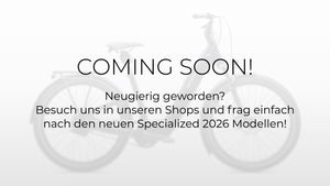 Bildaufschrift: "Coming Soon! Neugierig geworden? Besuch uns in unseren Shops und frag einfach nach den neuen Specialized 2026 Modellen", Platzhalterbild, da Produktbild noch nicht vorhanden, im Hintergund dezent ein verschwommen abgebildetes E-Bike